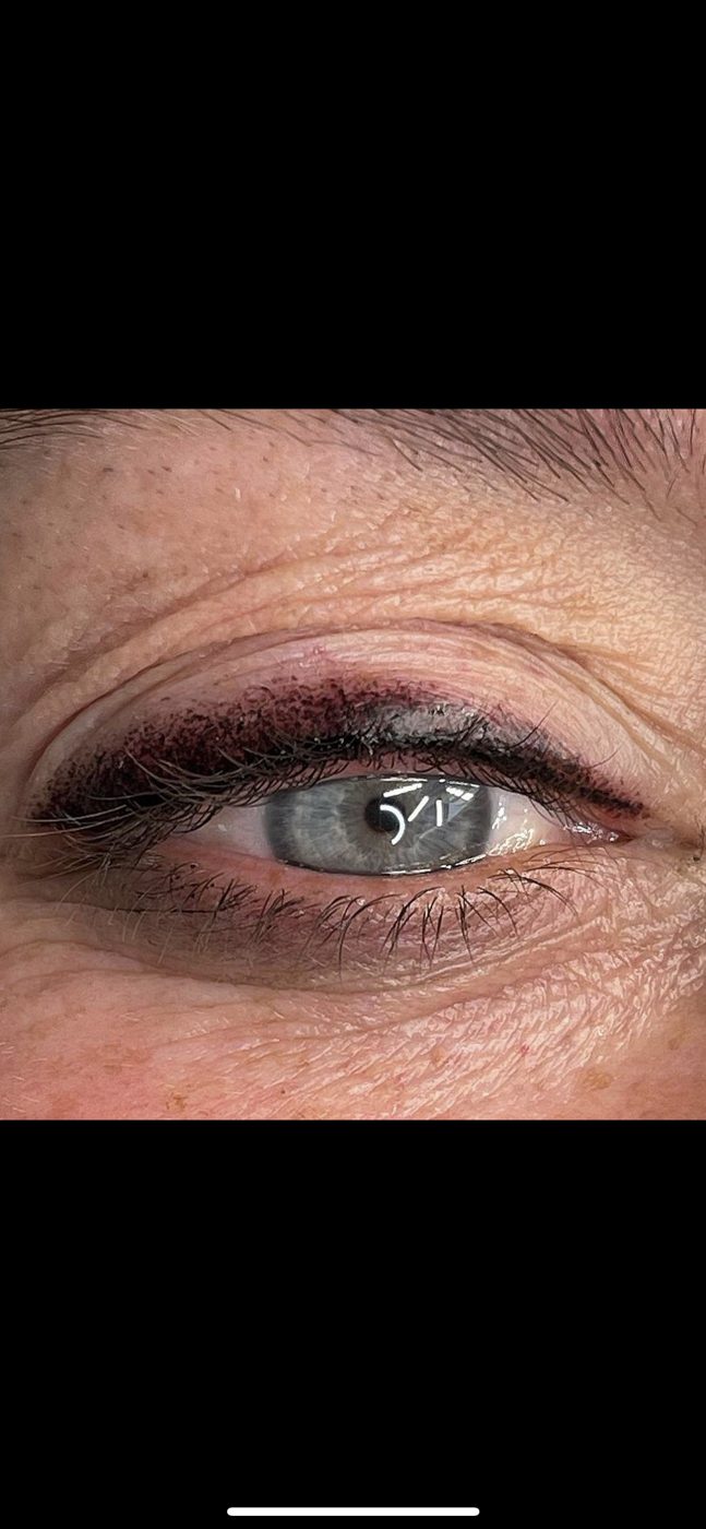 A close up of a woman 's eye with eyeliner.